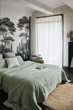 a bedroom with a large bed and wallpaper