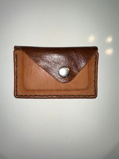 This rustic handcrafted wallet is made of high quality leather and slim enough to fit in your pocket with ease. Whether you're a minimalist or someone looking for a unique wallet, this can make a great option. Also, makes for a great gift for men during the holidays.  Features: -Handcrafted with high quality leather -Holds up to 5 credit cards, ID cards, drivers license, and folded cash -Slim & Minimalist  -Unique design -Added button for security Dimensions- 4.625L x 2.875H x .375W (inches)                        117.475L x 73.025H x 9.525W (mm) Follow my Instagram for updates! Instagram: @deadsailorleather Brown Waxed Finish Wallets As Gifts, Brown Leather Envelope Trifold Wallet, Gift Bi-fold Card Holder With Waxed Finish, Brown Leather Trifold Envelope Wallet, Brown Envelope Card Holder For Everyday Use, Leather Card Holder With Waxed Finish As Gift, Everyday Leather Envelope Card Holder, Minimalist Brown Wallet With Coin Pocket, Handmade Minimalist Brown Wallet