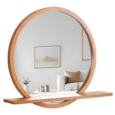 a living room scene with focus on the coffee table and large circular mirror above it