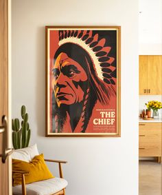 a native american chief poster hangs on the wall above a chair in a living room