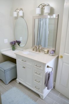 a bathroom with a sink, mirror and stool