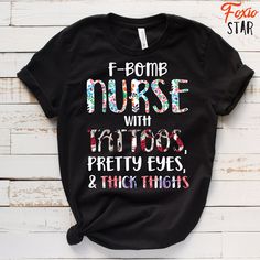 a t - shirt that says f bomb nurse with tattoos pretty eyes and thick thighs