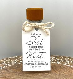 a small bottle with a tag on it that says take a shot we tried the knot