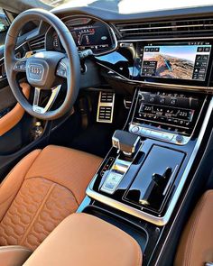 the interior of an audi car with dashboard controls, steering wheel and center console area