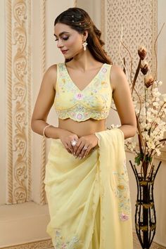 Buttercup yellow organza saree with multi colored floral jaal embroidery. Comes with embroidered blouse, potli bag and a petticoat.
Components: 4
Pattern: Embroidered
Type Of Work: Floral Jaal
Neckline: V Neck
Sleeve Type: Sleeveless
Fabric: Bustier: Silk, Saree: Viscose Organza, Petticoat: Modal Satin
Color: Yellow
Other Details: 
Scalloped edge saree
Tassel hem potli bag
Closure: Blouse: Side zip
Occasion: Wedding - Aza Fashions Yellow Organza Saree, Saree Tassel, Jaal Embroidery, Saree Tassels, Potli Bag, Buttercup Yellow, Blouse For Women, Organza Saree, Satin Color