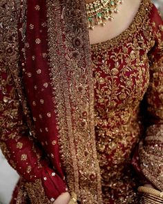 a woman in a red and gold wedding outfit