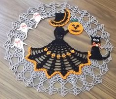 a crocheted doily with halloween decorations on it