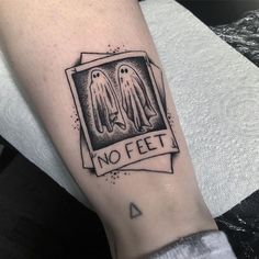 a person with a tattoo on their arm that says no feet and two ghostes