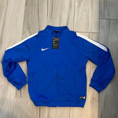 Nwt Youth Nike Jacket. Bought For Daughter’s Soccer Team & Never Ended Up Using It. Has Been In Bag Until Today When I Opened It To Take The Pics. Royal Blue. Youth Large. Unisex Nike Blue Track Jacket For Spring, Nike Blue Outerwear For Fall, Blue Nike Outerwear For Fall, Nike Blue Track Jacket Sportswear, Nike Blue Hooded Windbreaker, Nike Blue Sportswear Track Jacket, Nike Moisture-wicking Track Jacket For Sports Season, Blue Long-sleeved Nylon Track Jacket, Kids Nike