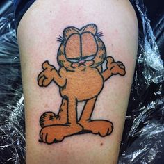 a cartoon character tattoo on the leg