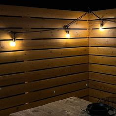 a table with some lights on top of it in a room that has wood paneling