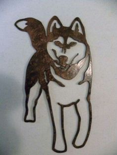 a metal cut out of a dog on a white background