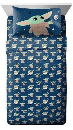 the child yoda bedding set is shown in blue and has stars on it