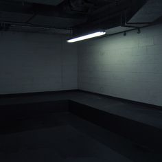 an empty room with some lights on the ceiling and no one in it at all