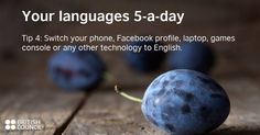 a blueberry sitting on top of a wooden table next to some text that says your languages 5 - a - day