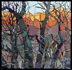 a stained glass window with trees in the background