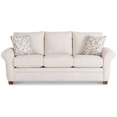 a white couch with two pillows on it