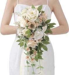 a bride holding a bouquet of flowers in her hands