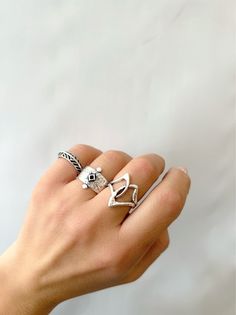 Discover the perfect set of handcrafted silver rings on Etsy. Embrace the harmonious essence of these three unique designs, each with their own distinct flair. The first ring showcases an asymmetrical charm, formed by two interconnected parts. The second ring, a wide band, captivates with a vibrant rhombus enamel centerpiece. Completing the set, a delicate leaf-inspired design adorns the slim band. Enjoy these adjustable rings both separately or combined, exclusively available at Christina Chris Unique Handmade Silver Heart Ring, Artisan Silver Stackable Rings As Gift, Bohemian Sterling Silver Ring, Handmade Silver Stackable Promise Rings, Handmade Bohemian Heart Ring Gift, Bohemian Handmade Heart Ring Gift, Artisan Sterling Silver Rings With Unique Variations, Artisan Handmade Silver Stackable Rings, Bohemian Stackable Sterling Silver Rings