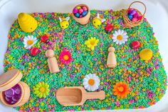 a play mat with toys and flowers on it