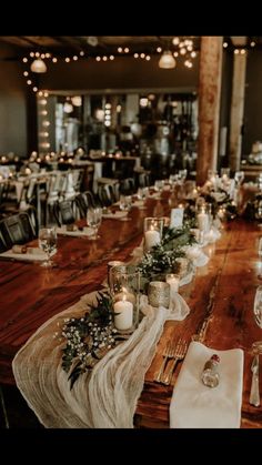 the table is set with candles and place settings