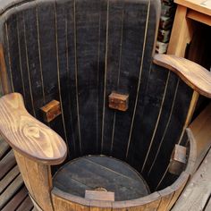 an old wooden barrel chair sitting on top of a wooden floor