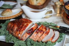 a sliced turkey sitting on top of a white plate