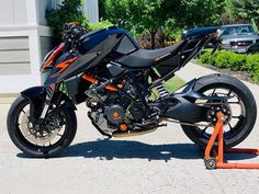 a black motorcycle parked on top of a parking meter