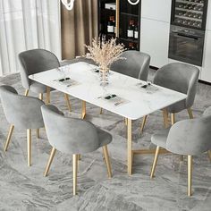 a dining room table with grey chairs and a white marble top