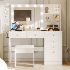 a white dressing table with lights on it