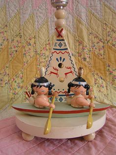 two figurines sitting on top of a table