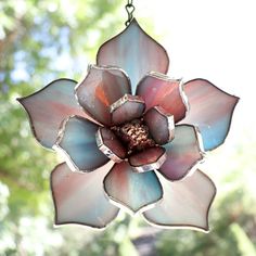 a stained glass flower hanging from a chain