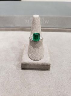 For Sale on 1stDibs - This exquisite and stunning three-stone engagement ring showcasing 2.77 carat emerald cut Colombian green emerald in the center, flanked by two brilliant Three Stone Engagement, Three Stone Engagement Rings, Stone Engagement, Green Emerald, Emerald Diamond, Three Stone, Emerald Cut, Emerald Green, Engagement Ring