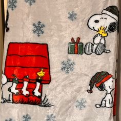 a snoopy christmas blanket with peanuts on it