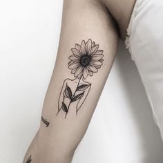 a black and white photo of a sunflower on the arm