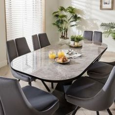 a dining room table with chairs around it