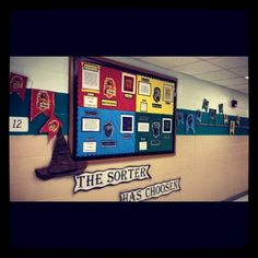 a school hallway with posters on the wall and writing on the bulletin board that says, the sorter has chosen