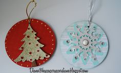 two ornaments are hanging on the wall next to each other, one has a snowflake ornament