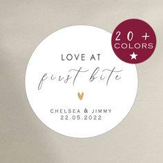 a white round sticker with the words love at first bite on it and a red circle