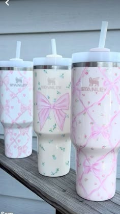 three different colored tumblers with bows on them