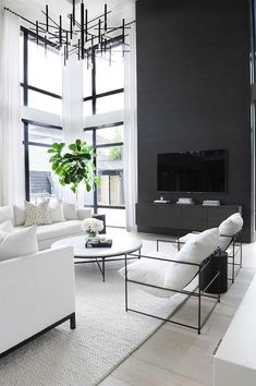 a living room filled with furniture and a flat screen tv mounted on a wall above a fireplace