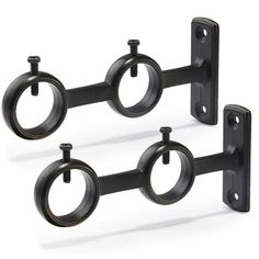 three black metal brackets with rings on them