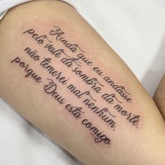 a woman with a tattoo on her arm that reads, and the words are written in cursive font