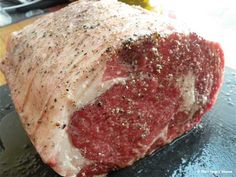 a piece of raw meat sitting on top of a cutting board