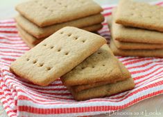 some cookies are sitting on a red and white towel with a striped cloth around it