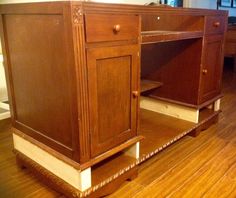 a kitchen with wooden floors and cabinets in it