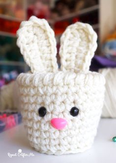 a crocheted bunny is sitting on a table