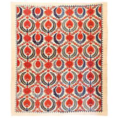 a red and blue rug with circular designs on it