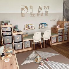 a child's playroom with toys and storage bins