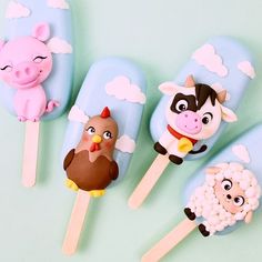 five pops with farm animals on them sitting next to each other in front of a blue background